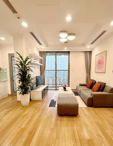 a living room with a couch and a table at KABILUX HOUSE - 1-2-3 Bedrooms in Vinhomes Times City in Hanoi