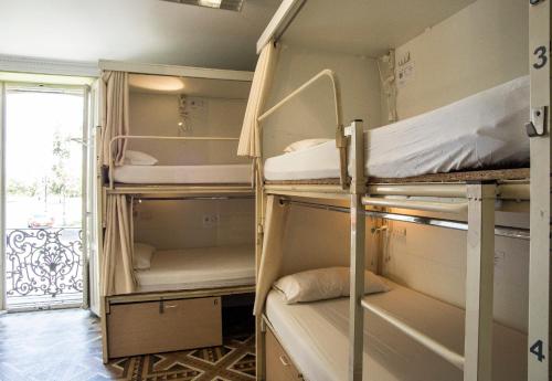 Una cama o camas en una habitación de River Hostel