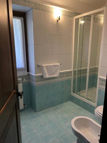 a bathroom with a toilet and a sink and a shower at Casale La Quercia in Poggio Bustone