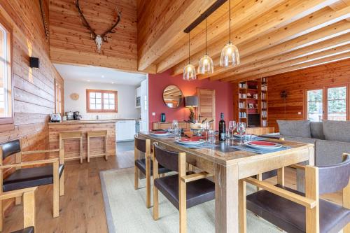 a kitchen and living room with a wooden ceiling at Croix Noires FABULOUS & LUXURY chalet 11 pers by Alpvision Résidences in Vex