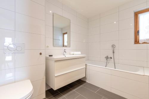 a white bathroom with a sink and a tub and a toilet at Croix Noires FABULOUS & LUXURY chalet 11 pers by Alpvision Résidences in Vex