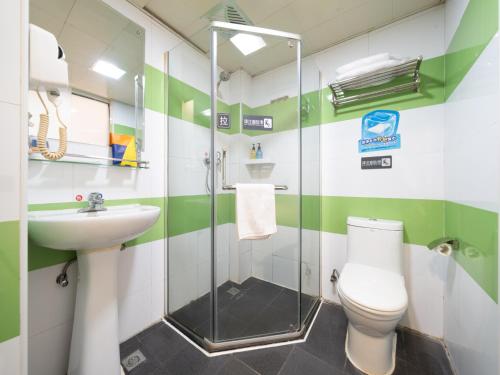 a bathroom with a shower and a toilet and a sink at 7Days Inn Railway Station Xi'an Wulukou Subway Station in Xi'an