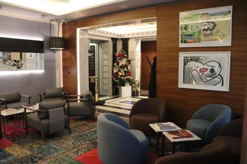 a waiting room with chairs and a christmas tree at Zepter Hotel Belgrade, member of Zepter Hotels in Belgrade