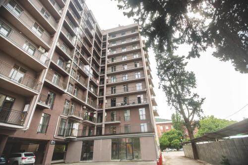 an apartment building with balconies on the side of it at Twins Tower 5 in Tbilisi City