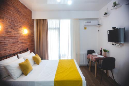 a hotel room with a bed and a television at Twins Tower 5 in Tbilisi City