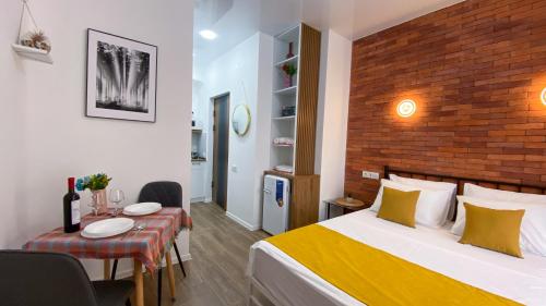 a hotel room with a bed and a dining table at Twins Tower 5 in Tbilisi City