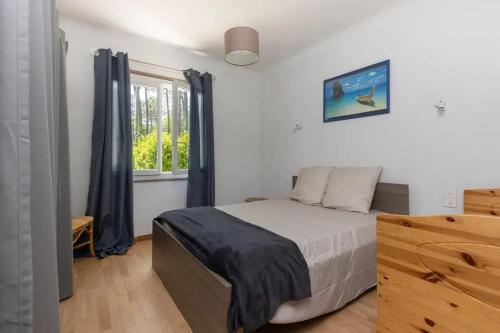 une chambre avec un lit et une fenêtre dans l'établissement Maison ensoleillée avec piscine privée à Moliets-et-Maa, à Moliets-et-Maa