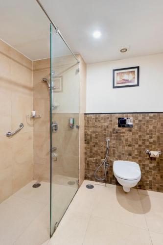 a bathroom with a shower and a toilet at Sterling Mussoorie in Mussoorie