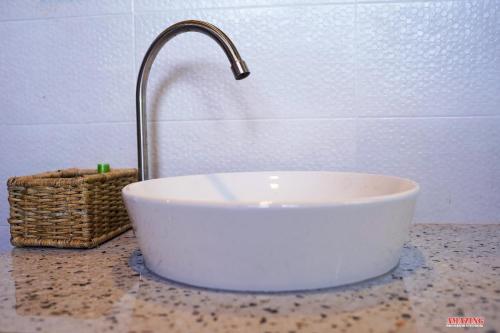 a white sink with a faucet on a counter at Cinnamon Hills Cabana in Alutwala