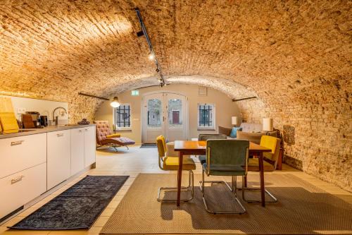 a kitchen and living room with a table and chairs at Luxurious renovated apartment in Utrecht City center with view on the old canal in Utrecht