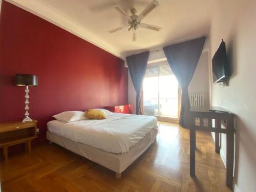 une chambre avec un lit et un ventilateur de plafond dans l'établissement Cosy 70m terrasses- Clim - Nice centre Libération, à Nice