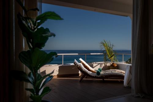 a room with a balcony with a view of the ocean at Porto Santo Precious Oceanview in Campo de Baixo