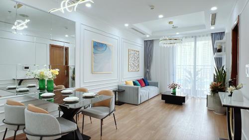 a large living room with a table and chairs at KABILUX HOUSE - 1-2-3 Bedrooms in Vinhomes Times City in Hanoi