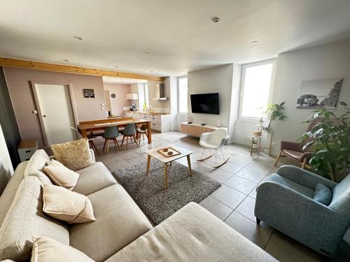 a living room with a couch and a table at Appart du faubourg in Valence