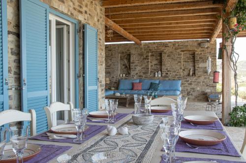an outdoor patio with a table and chairs at Hacienda house in Andiparos