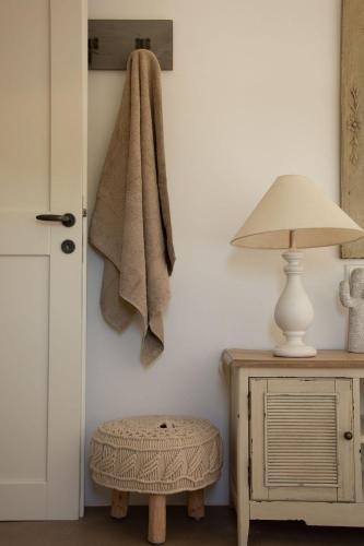 a towel hanging on a wall next to a lamp at Hacienda house in Andiparos