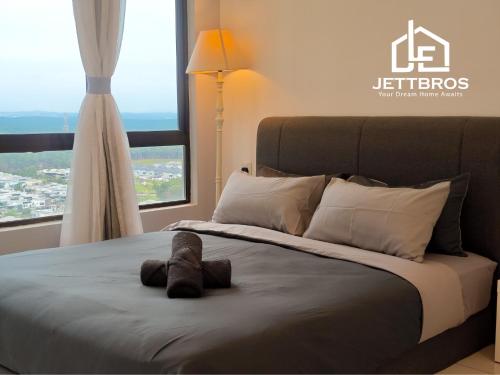 a bed with a stuffed animal on top of it at D' Summit Residence By JettBros Johor Bahru in Johor Bahru