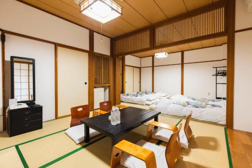 a living room with a table and chairs at Hotel Jogakura in Aomori