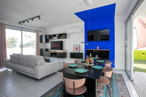 a living room with a couch and a table at Palmove Renovated Meneou House in Larnaca