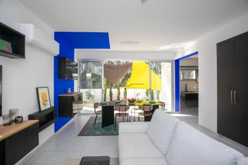a living room with a white couch and a table at Palmove Renovated Meneou House in Larnaca