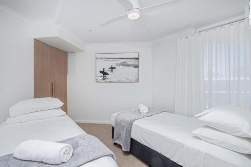 Ένα ή περισσότερα κρεβάτια σε δωμάτιο στο Crystal Beachfront Apartments