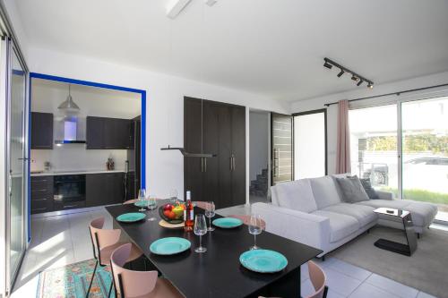 a living room with a table and a couch at Palmove Renovated Meneou House in Larnaka