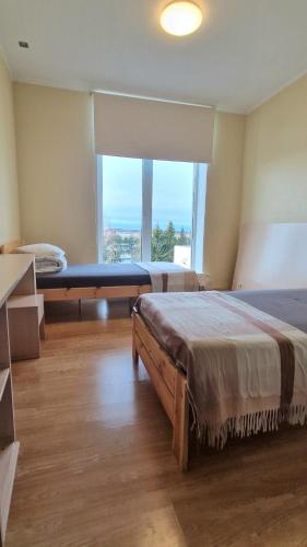 a bedroom with two beds and a large window at Vinni Sport & Spa hostel in Vinni