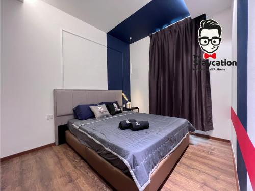 a bedroom with a bed with a blue head board at Staycation Homestay 38 Viva J2 near Tabuan in Kuching