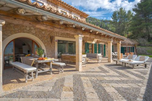 an outdoor patio with a table and chairs at La Zalema in Esporles