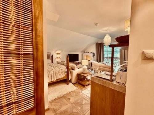 a bedroom with a bed and a living room at SEIN Boutique Suites - ADULTS ONLY in Gosau