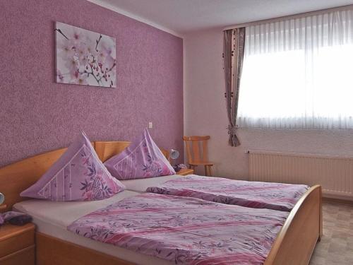a bedroom with two beds with pink walls and a window at Haus Sonnenblick in Fischbach bei Dahn