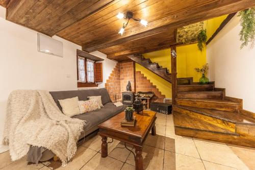 a living room with a couch and a staircase at La Congosta, mágica aldea rodeada de montañas in La Plaza