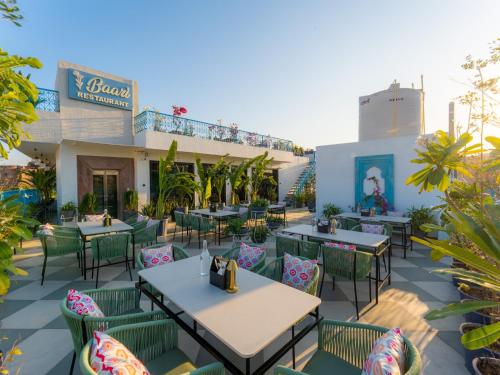 an outdoor patio with tables and chairs at Moustache Jodhpur in Jodhpur