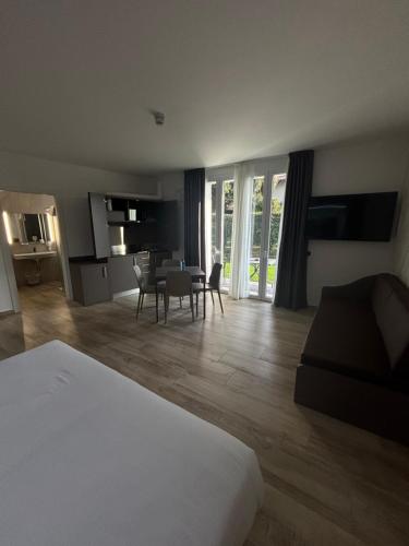 a room with a bed and a table and chairs at Bis Hotel Varese in Varese