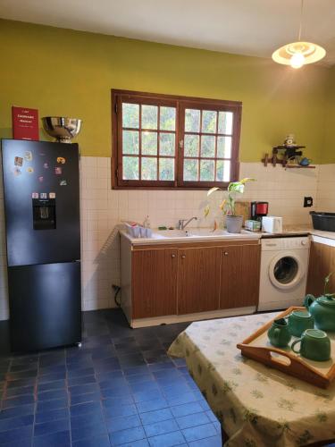 La cuisine est équipée d'un réfrigérateur noir et d'un évier. dans l'établissement CASA DI SIGNARE, à Ventiseri