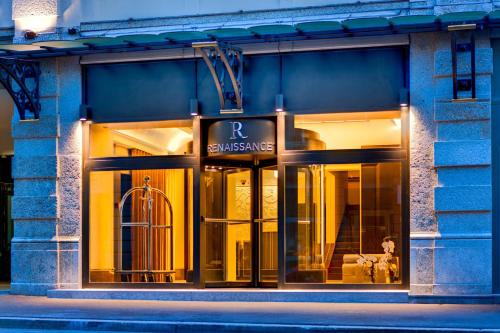 a store front of a building with a sign on it at Renaissance Lucerne Hotel in Luzern