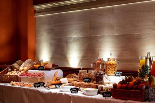 a table with bread and other food on it at Renaissance Lucerne Hotel in Luzern