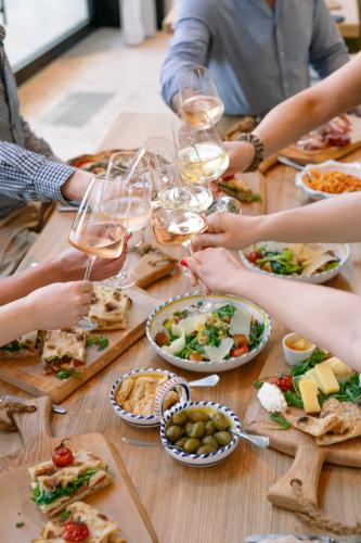 a group of people sitting around a table with wine glasses at A-ROSA Gardasee in Salò