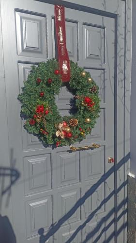 a door with a christmas wreath on it at Elichrysos GuestHouse Konitsa in Konitsa