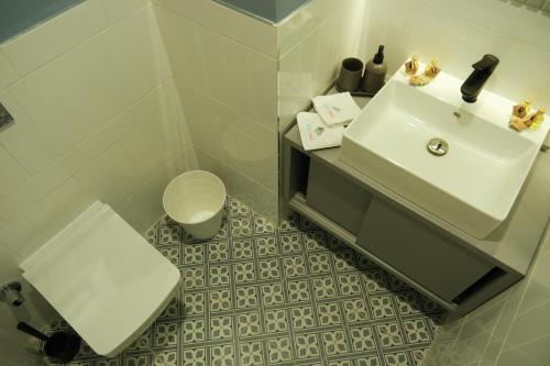 a bathroom with a white sink and a toilet at Bird Nest Suites in Istanbul