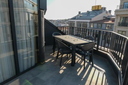 a balcony with a table and chairs on a balcony at Bird Nest Suites in Istanbul