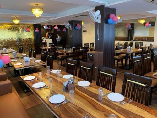 a dining room with tables and chairs and balloons at Hotel opal plaza executive in Waluj Buzurg