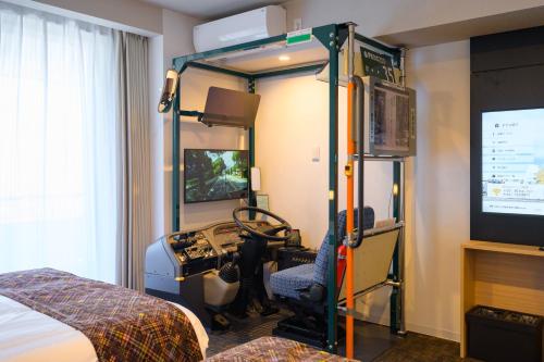 a room with a bedroom with a room with a bed and a tv at Sanco Inn Iseshi-Ekimae Shikinoyu in Ise