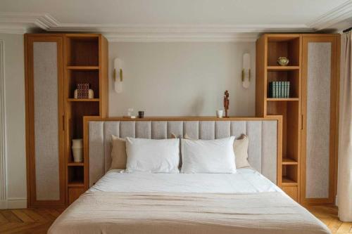 - une chambre avec un grand lit et des étagères en bois dans l'établissement Exceptional Duplex - AC-4BR-8P- close to Marais, à Paris