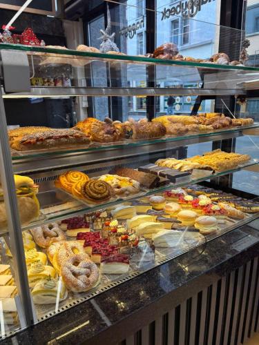 a display case with many different types of pastries at Nani City Hotel in Zürich