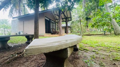 a stone bench in front of a house at Ela Addara Green Villa in Sigiriya
