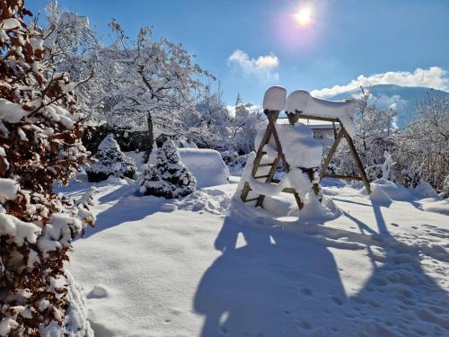 a swing in the snow with snow covered trees at Appartement Bergrose in Hopfgarten im Brixental