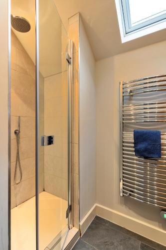 a shower in a bathroom with a glass shower stall at Finest Retreats - Oak Cottage in Bidford