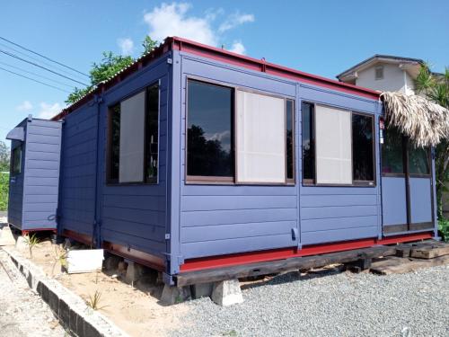 a blue tiny house sitting on the ground at Cabochon Camp - Vacation STAY 69145v in Ushuku