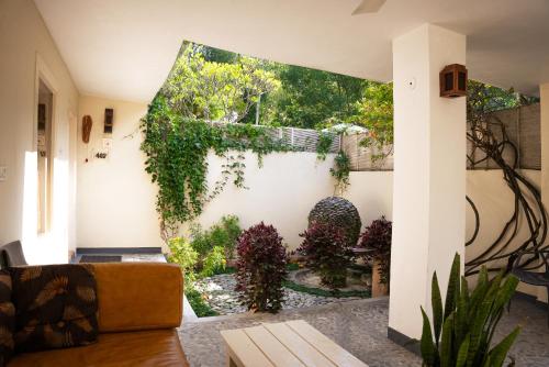 a living room with a couch and ivy on the wall at The Solluna Resort in Marchula